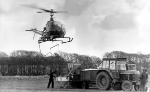 00375 Prints: Pilot Tony Daly at the controls of his Hiller 12E helicopter spreading fertiliser