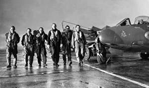 Pilots of 3613 Fighter Control Unit of the Royal Auxiliary Air Force make their way to