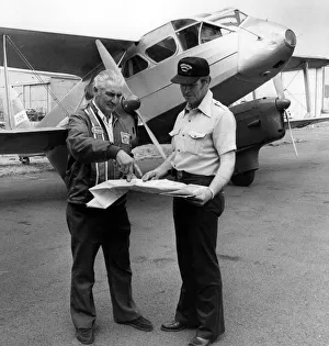 Canada Prints: Pilots Mr Geoge LeMay(left) and Mr Alf Bicknell discussing the flight plan to Canada