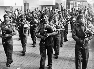 1946 Prints: The pipe band of the 8th punjab regiments on the deck of the RMS Mauritania
