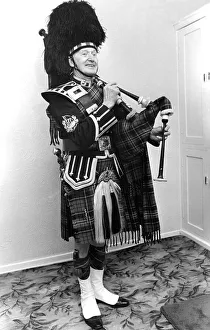 Bagpipes Prints: A piper smarly dressed in his uniforn and ready to play the bagpipes in March 1982