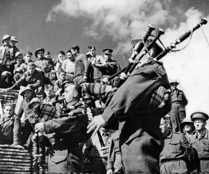 Pipers playing during an off duty spell to men of the Canadian Forestry Corps