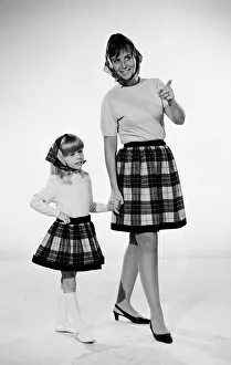 Plaid skirt fashion shoo. Mother and daughter in matching check skirts