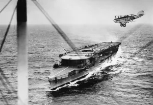 Planes Prints: A plane from HMS Furious passing over the aircraft carrier while manoeuvering to alight