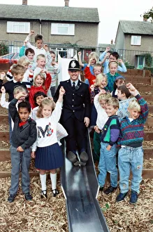 Slide Prints: Playtime... community constable PC Adrian Denby tests the slide in Reinwood Infant