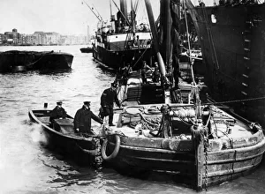 Thames Prints: Police Centenary. Metropolitan river police bring their boat alongside a barge while one