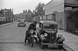 A police motorcyclists issues a warning to a motorist in Hampton, Middlesex