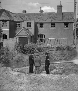 Police Officers inspect the damage to Clent school following a German air raid