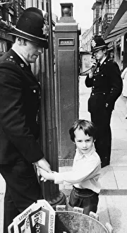Officer Prints: Police officers with a little boy who is lost in the city centre of Cambridge