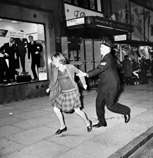 Police try to control fans in the streets of Liverpool before the premiere of the Beatles