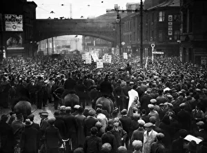Police watch a demonstration of unemployed workers organised by the National Unemployed