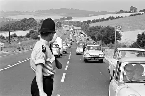 00109 Prints: Policeman directing August Bank Holiday taffic on the A20