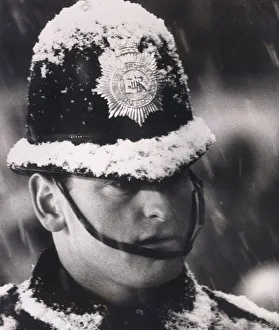 Policeman on duty at the Arsenal v Sheffield Wednesday football match at Highbury covered
