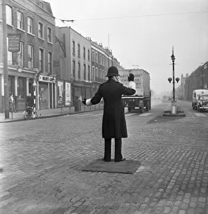 A policeman on point duty at the junction of Commercial Road with the junction of East