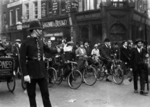Strikes Prints: Policeman on traffic duty seen here directing cyclist and pedestrians on High Holborn