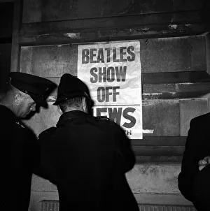 Policemen in Portsmouth, putting up posters which read BEATLES SHOW OFF