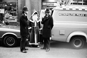 Policemen speak to Santa Claus outside the Harrods Store in London