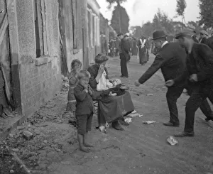 Poor Belgian woman outside her burnt out home in Melle with her two children