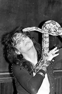 Reptiles Prints: Pop singer Alice Cooper aged 23 flew into Heathrow Airport today with his pet boa
