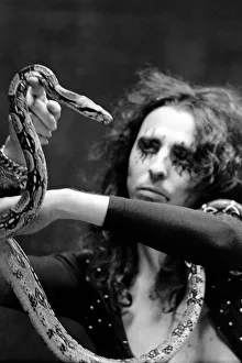 Reptiles Prints: Pop singer Alice Cooper aged 23 flew into Heathrow Airport today with his pet boa