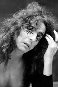 00274 Prints: Pop singer Alice Cooper aged 23 flew into Heathrow Airport today with his pet boa