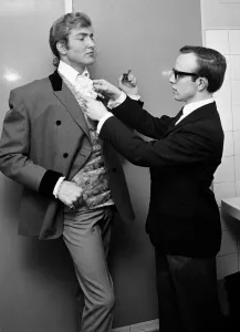 Pop singer Beau Brummel receives a helping hand with his cravatte from his valet Jeffers
