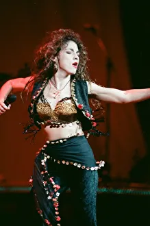 Microphones Prints: Pop singer Gloria Estefan performing on stage during a concert in Britain 24th