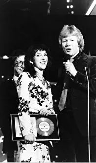 00188 Prints: Pop singer Kate Bushholds her award as she stands with Radio 1 Disc Jockey David Kid