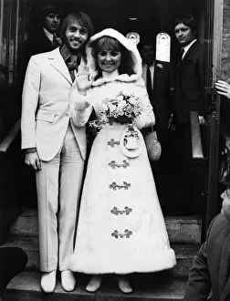 Pop singer Lulu wearing a maxi dress as she poses with the groom Maurice Gibb of the Bee