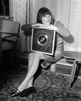 Pop singer Sandie Shaw holding the Silver Disc award for selling 250 000 copies of her