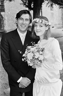 Marriage Prints: Pop star Bryan Ferry poses with his bride Lucy Helmore after thier wedding ceremony at St