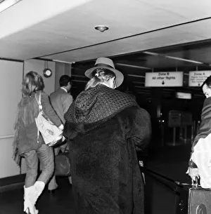 Pop star Elton John pictured showing off his pony tail as he arrives at London