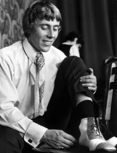 Pop Star Ray Phillips of the Nashville Teens tries on some hand made shoes in Chelsea