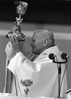 Religious Service Prints: Pope John Paul II blessing the wine during an open air mass held at Wembley Stadium
