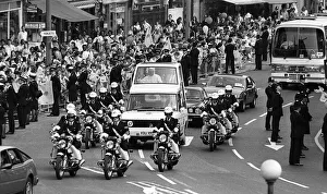 Pope John Paul II during his visit to Britain in 1982 rides along in his Popemobile