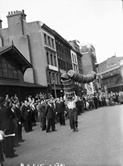 Porters from Covent Garden Flower and Vegetable market race with baskets stacked on their