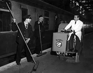 Rail Prints: Porters John Healy and and Robert White armed with brooms pause to look at the new magpie