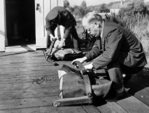 Two Men Only Prints: Post Office workers prepare the fitted pouches ready for the quick-release nets so
