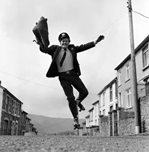 Mail Prints: Postman Mr. Fred Henderson in happy mood as he delivers his mail. April 1975