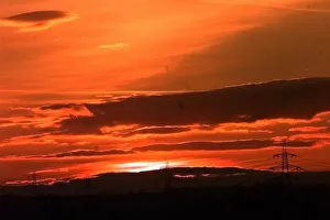 Electricity Prints: Powerlines cross the farmland just outside Lichfield as the Sun sets