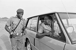 Images Dated 26th May 2011: President Idi Amin at the wheel of his Range Rover speaking to one of his bodyguards at