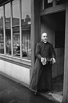 One Man Only Prints: A priest plays a concertina outside Crabbs Concertina Shop in Liverpool Street