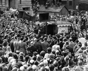 Prime Minister Winston Churchill surrounded by huge crowds of people on his visit to