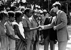 African Prints: Prince Andrew at Dar Es Salaam during a visit to East Africa shaking hands with students