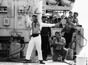 Prince Charles acting as batman to guide the helicopter of HMS Jupiter flight deck