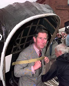 Prince Charles carries a coracle July 1998 during his visit to the Swansea Maritime