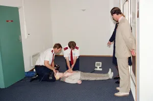 Dummy Prints: Prince Charles being demonstrated resuscitation techniques on an inflatable doll at an