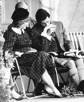 Prince Charles kisses the hand of Princess Diana during the annual Braemar Highland Games