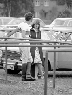 Prince Charles leans back on to railings as he chats with Camilla Parker Bowles during a