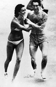 Swimming Prints: Prince Charles plays with model Jane Priest on Cottesloe Beach, Perth, Western Australia